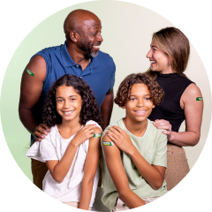 Happy family wearing green Harveys Supermarket pharmacy bandage.