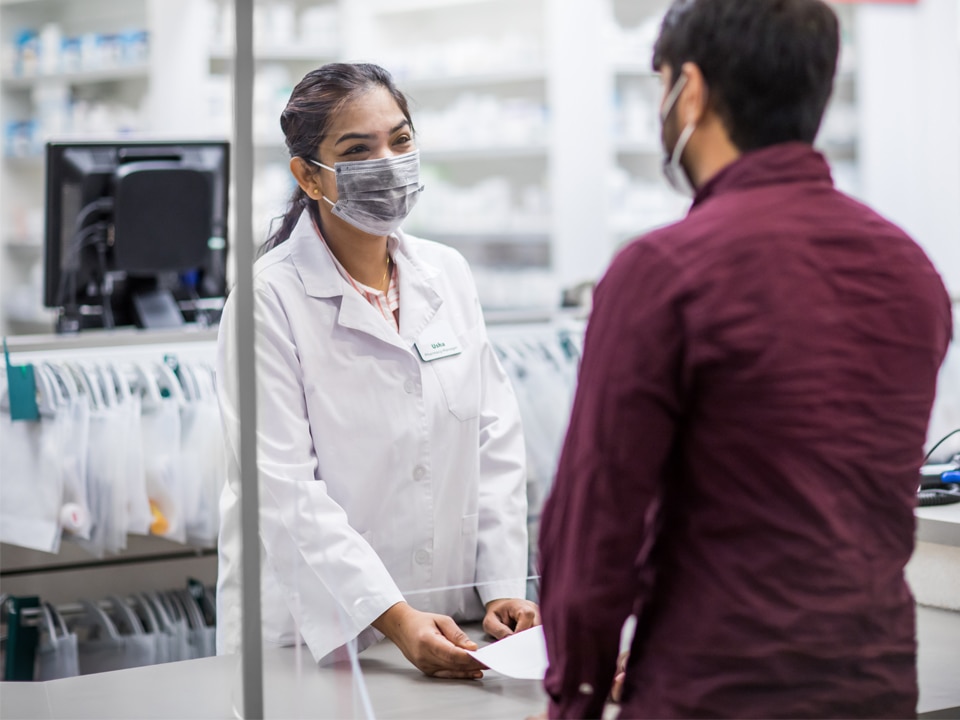 Harveys Pharmacy - Pharmacist discussing COVID-19 Vaccine with customer