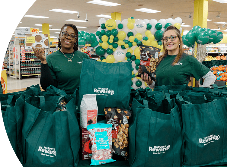 Harveys Supermarket employees smiling with bags of groceries