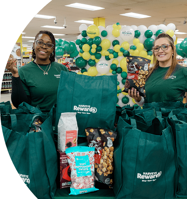 Harveys Supermarket employees smiling with bags of groceries