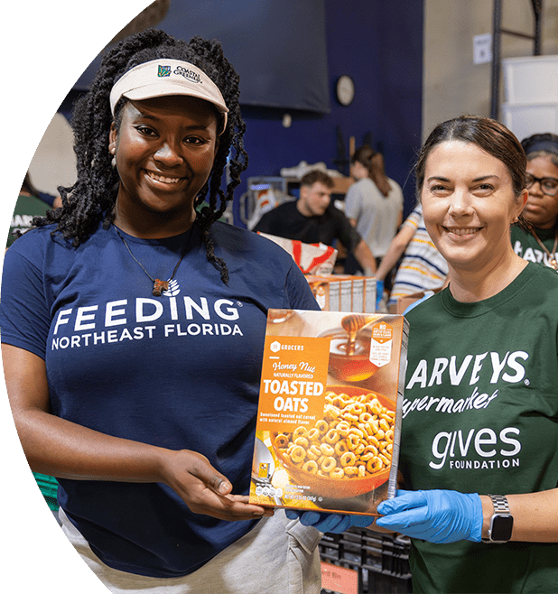 Gives Foundation volunteers holding an SE Grocers Toasted Oats product.