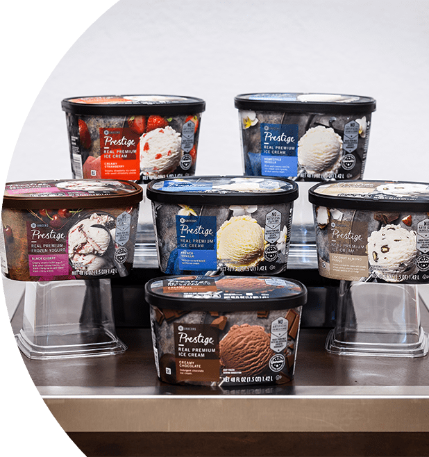 48 oz SE Grocers ice cream tubs of various flavors placed on a table.