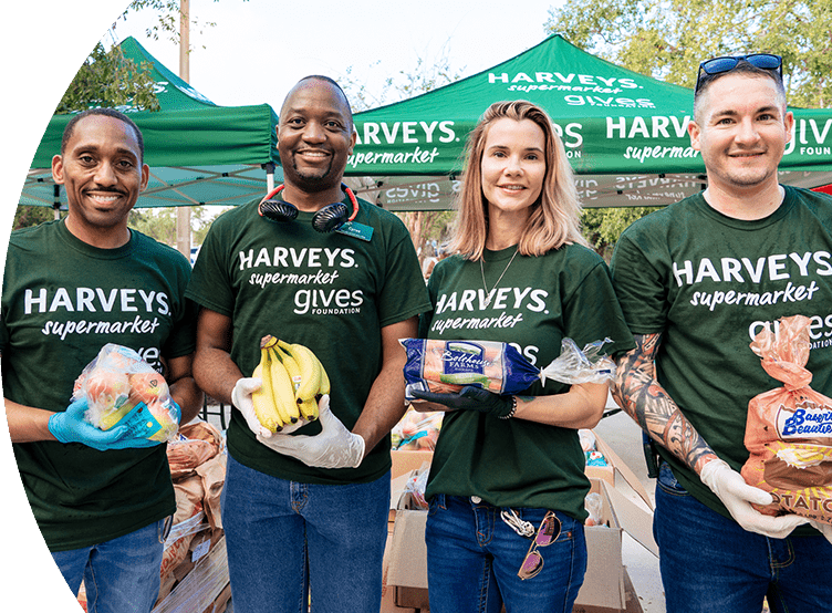 Group of Harveys Supermarket Give Foundation volunteers assisting with donations.