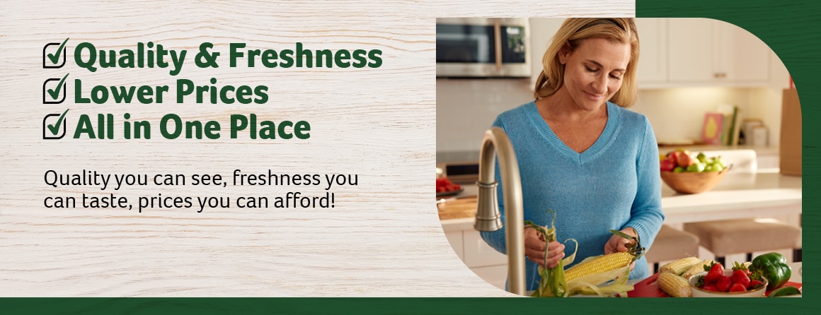 A woman in a blue sweater husking corn at a kitchen counter surrounded by fresh produce, including strawberries, bell peppers, and corn. The design incorporates Harveys' green-themed branding. The text reads:  