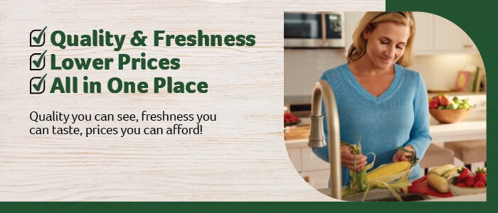 A woman in a blue sweater husking corn at a kitchen counter surrounded by fresh produce, including strawberries, bell peppers, and corn. The design incorporates Harveys' green-themed branding. The text reads:  
