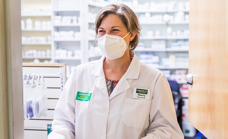 Harveys Supermarket pharmacist wearing a white face mask