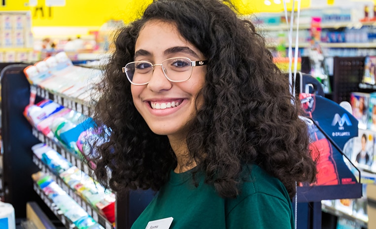 Smiling Winn-Dixie cashier checking out items