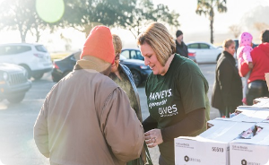 Harveys Supermarket gives foundation volunteer gathering donations.